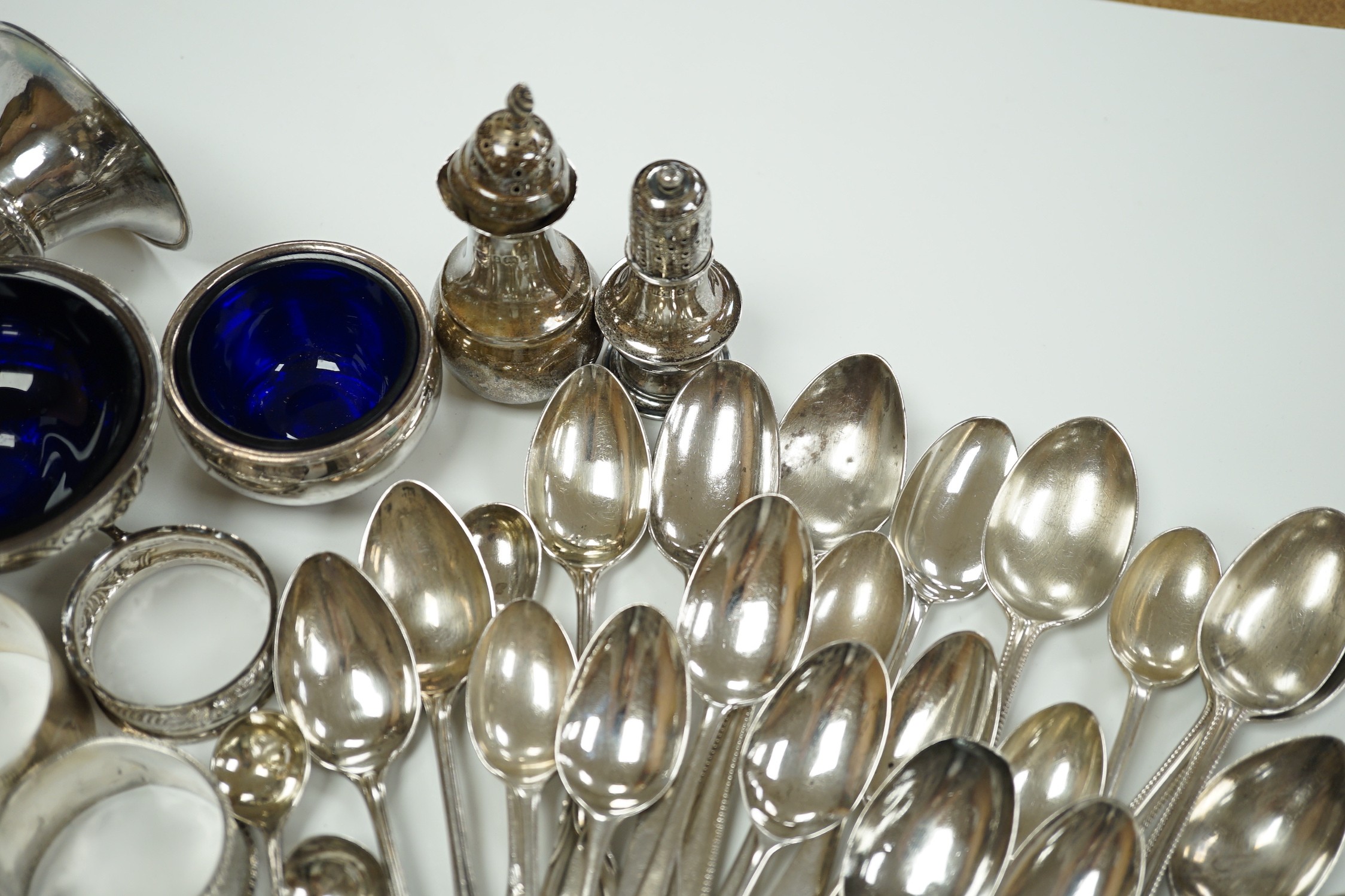 A small collection of assorted small silver including five napkin rings, a posy vase, two pepperettes, two small salts including Irish(marks very rubbed) and twenty eight small spoons.